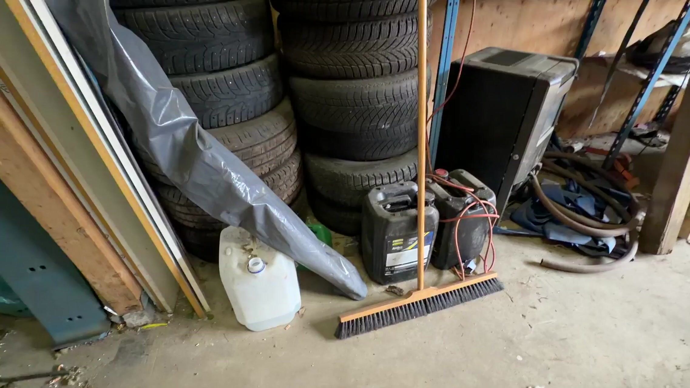 Metal shelving units with contents, ladders, etc.